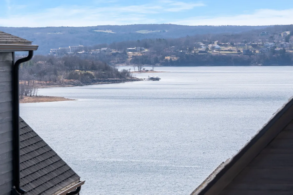 A tranquil lakeside view featuring the lake, distant hills, and a boathouse. The setting is peaceful, ideal for scenic walks and outdoor exploration, matching the section's emphasis on lakeside trails and nature activities.