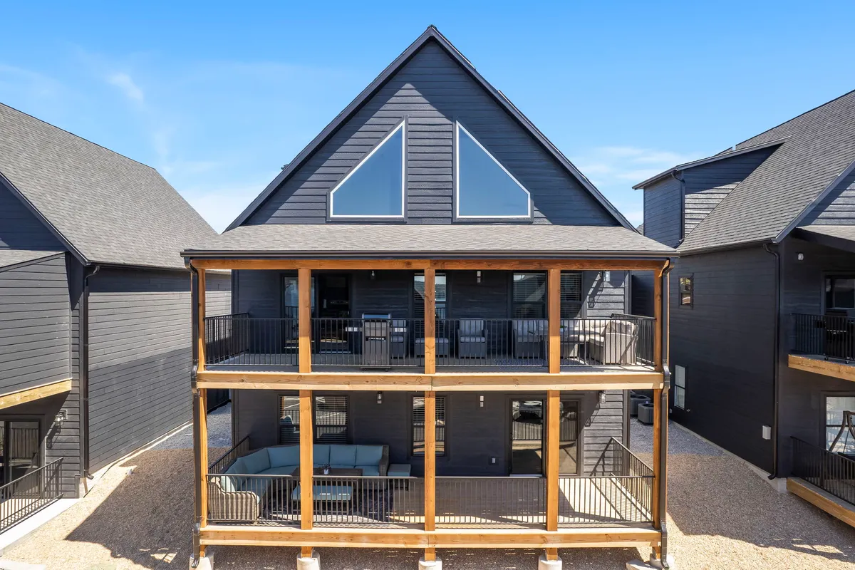 A modern exterior featuring spacious balconies and large windows, with geometric architecture that invites gatherings. The balconies offer ample space for outdoor socializing, enjoying the scenery, or sipping morning coffee as a group.